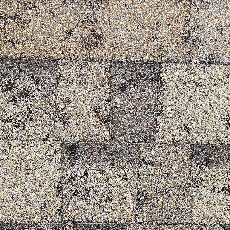 Asphalt roof shingles with hail damage close-up Asphalt roof shingles with hail damage close-up
