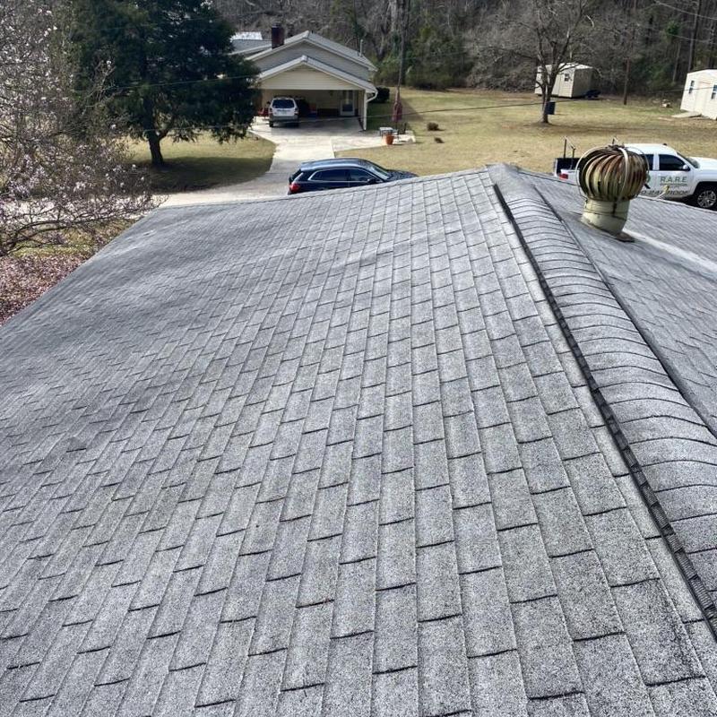 Asphalt shingle roof with turbine vent and ridge cap Asphalt shingle roof with turbine vent and ridge cap