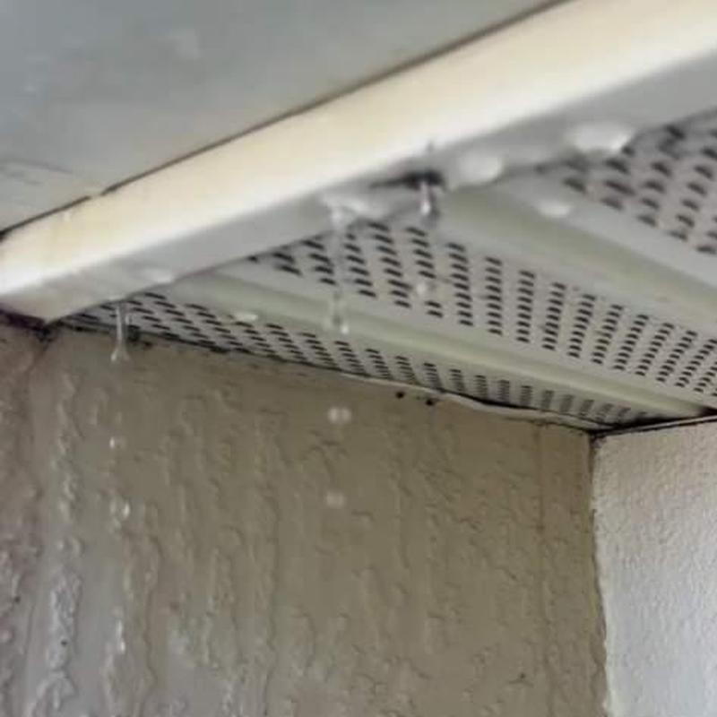 Concrete tile roof soffit with leaking water droplets