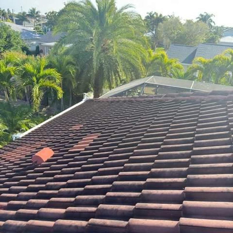 Concrete tile roof with damaged tiles and repairs