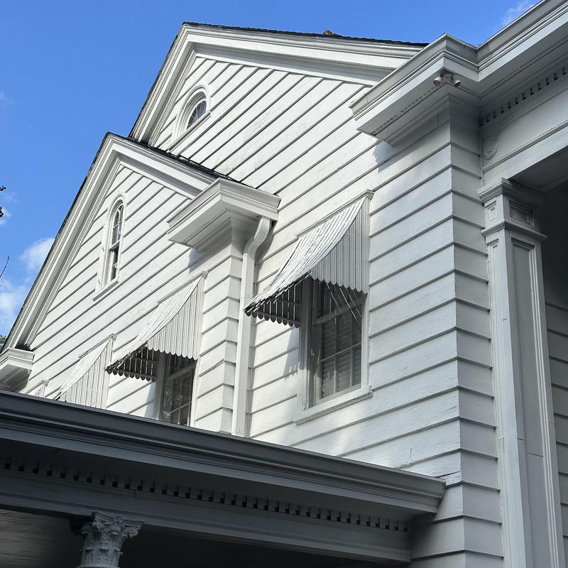 Siding and trim renovation on historic home exterior
