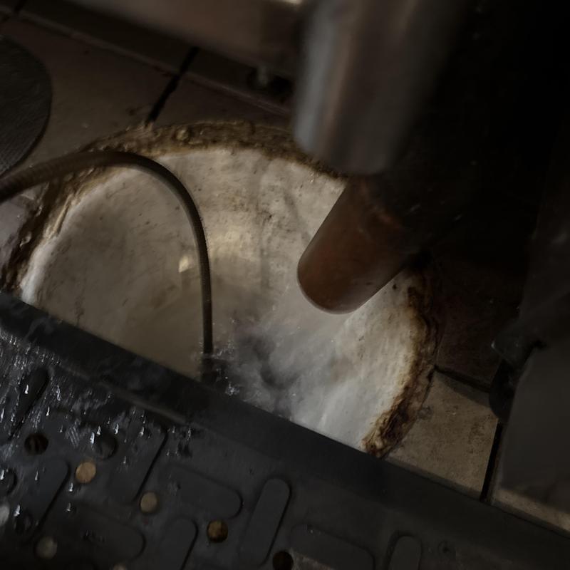 Commercial kitchen floor drain clearing with snake tool