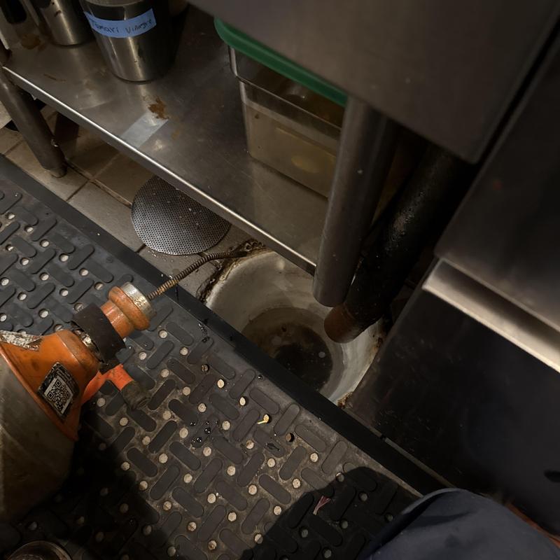 Commercial kitchen floor drain snake clearing buildup