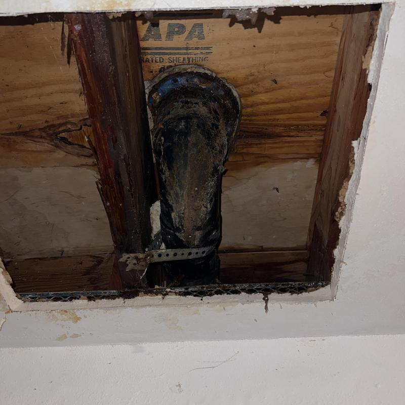 Toilet drain pipe with ceiling access hole and water damage