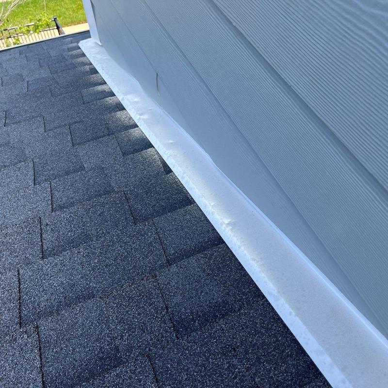 Asphalt shingle roof with white metal flashing installation