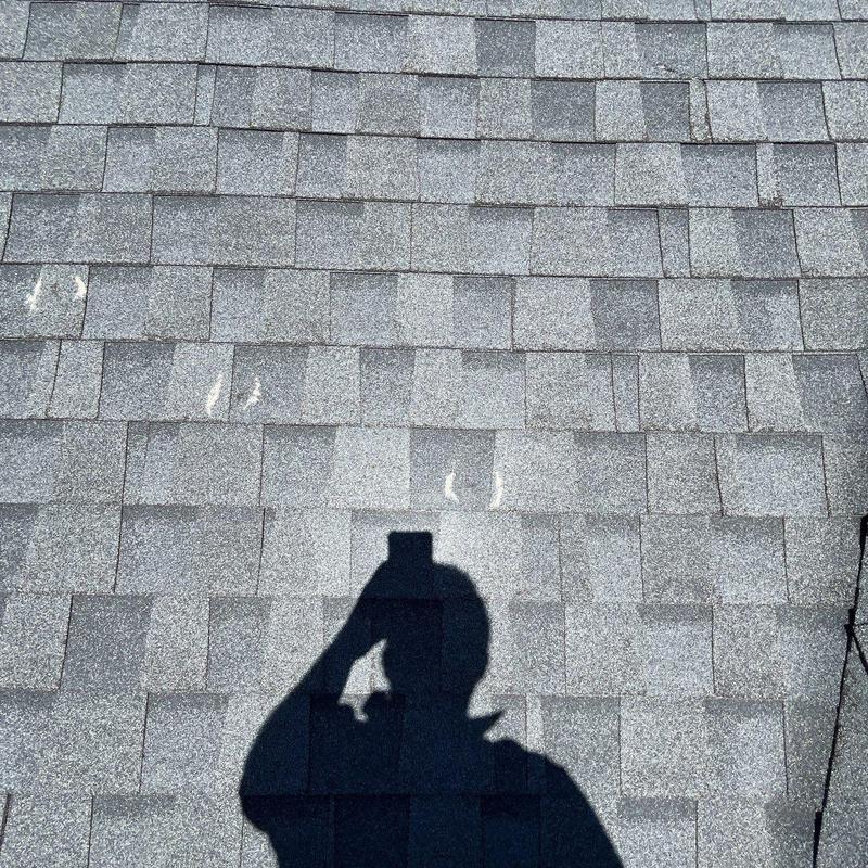 Asphalt shingles with visible hail damage marks