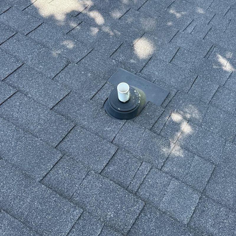 Roof pipe flashing on asphalt shingle roof with hail damage