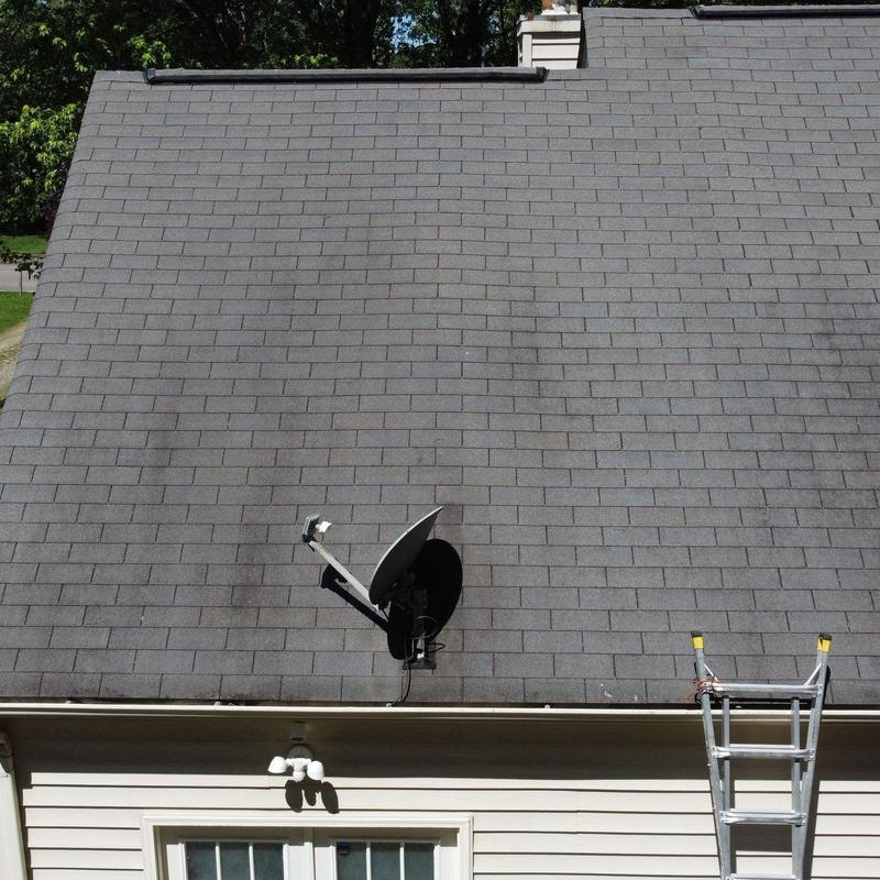 Roof shingles with hail damage and satellite dish