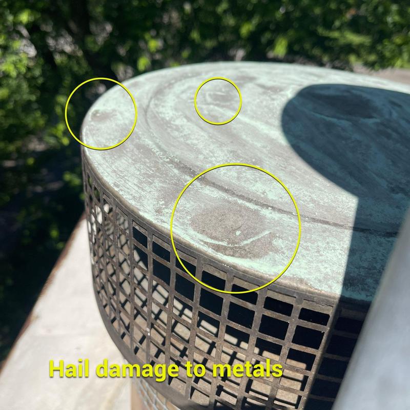 Metal vent cap with hail damage marks