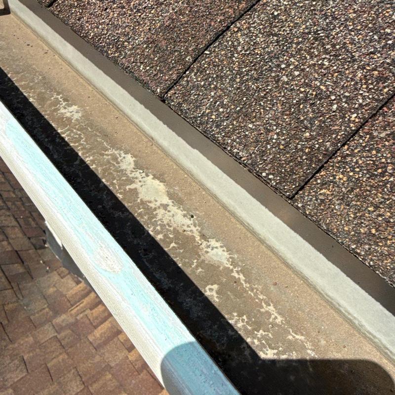 Asphalt shingle roof with metal flashing and gutter edge