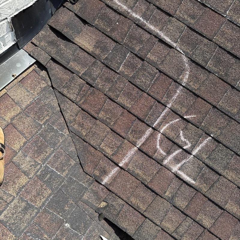Asphalt shingle roof with hail damage and chalk markings