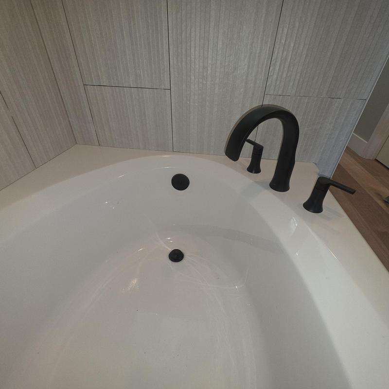 Roman tub faucet and valve trim installation in bathroom