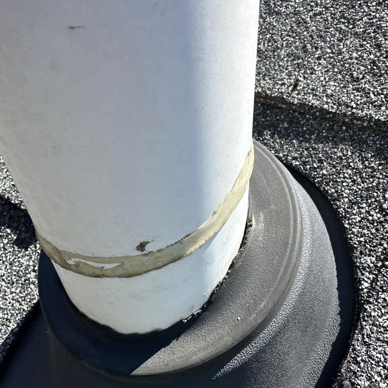 Roof vent pipe flashing with sealant on shingle roof