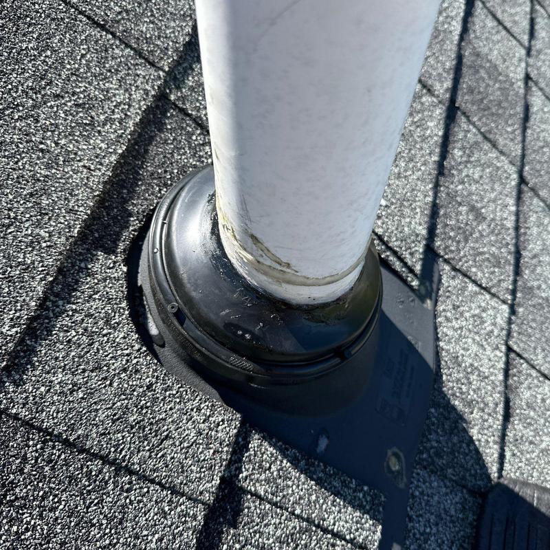Roof vent pipe flashing on asphalt shingle roof