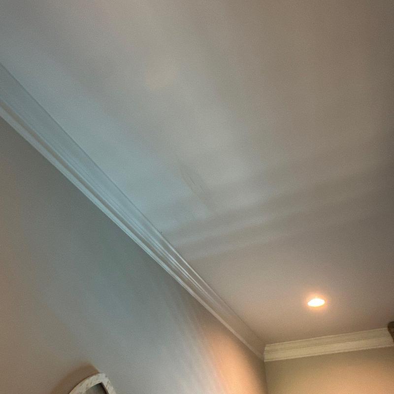 Ceiling drywall with visible water stain and crack