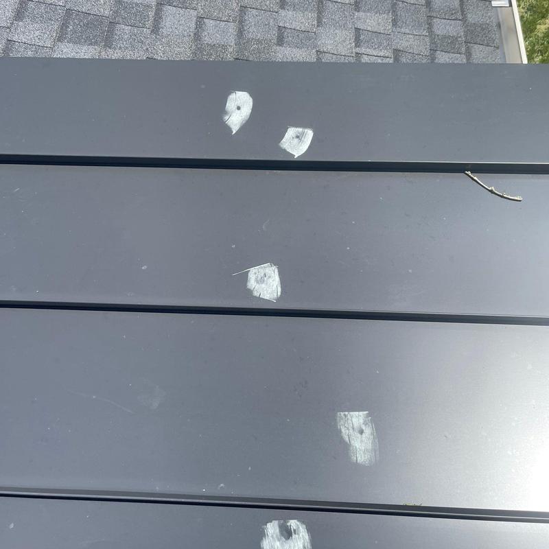 Metal roof panels with hail damage and dents