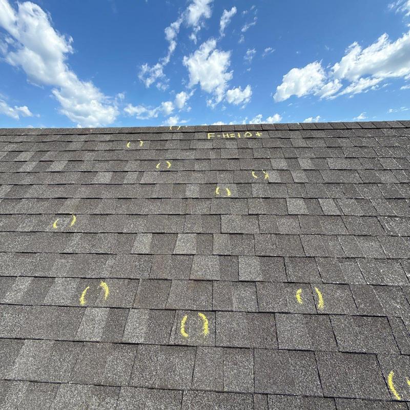 Asphalt roof shingles with marked hail damage inspection