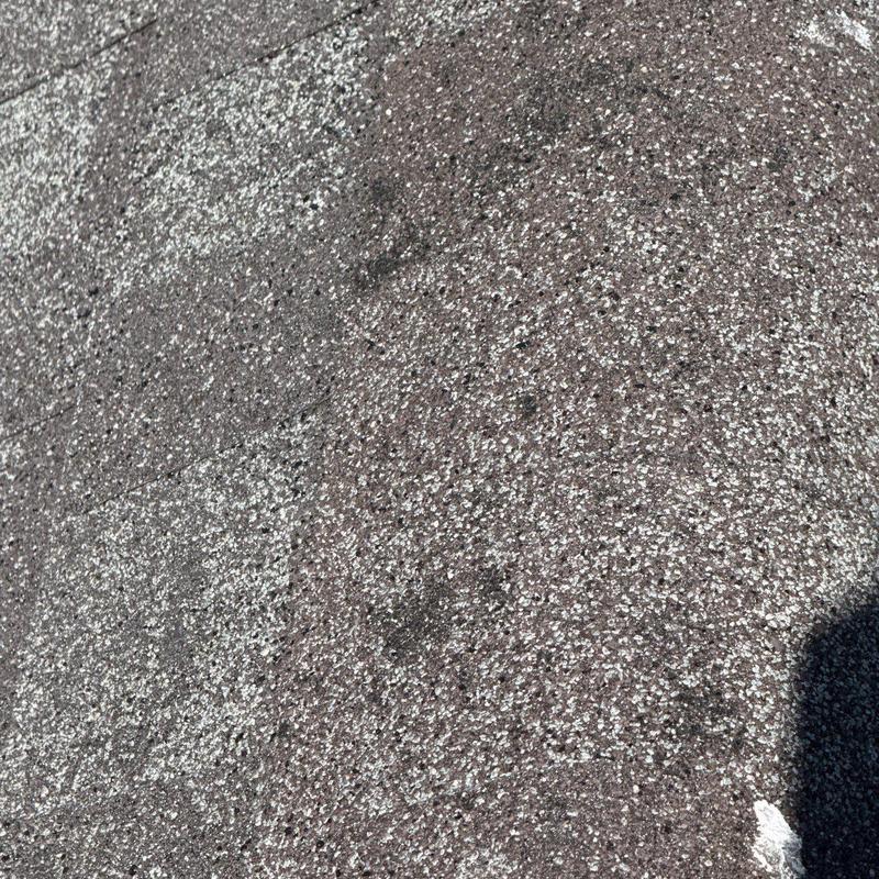 Asphalt roof shingles with hail damage close-up