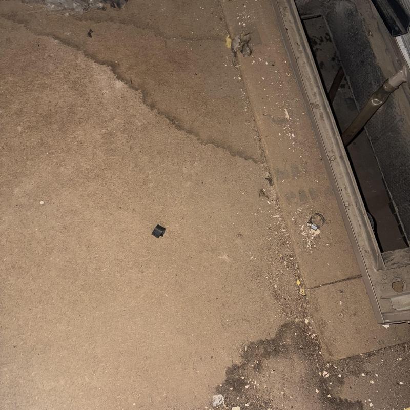 HVAC air handler interior with debris and dirt buildup