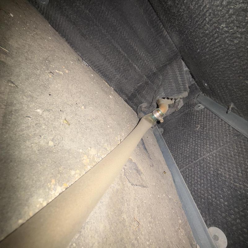 Drain pipe clamp connection in HVAC unit crawl space
