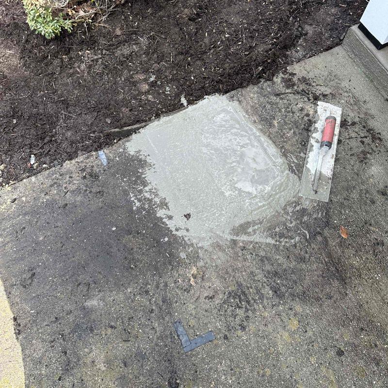 Concrete patch on excavated underground pipe site Concrete patch on excavated underground pipe site