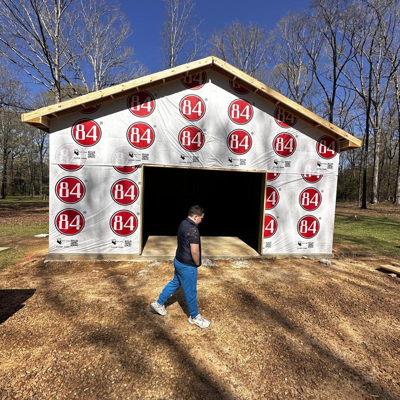 Shop building exterior with weather barrier installation