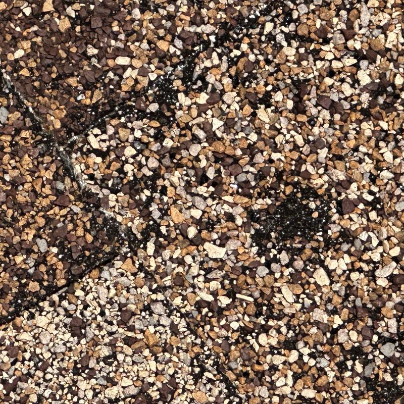 Roof granules with cracked asphalt shingle damage
