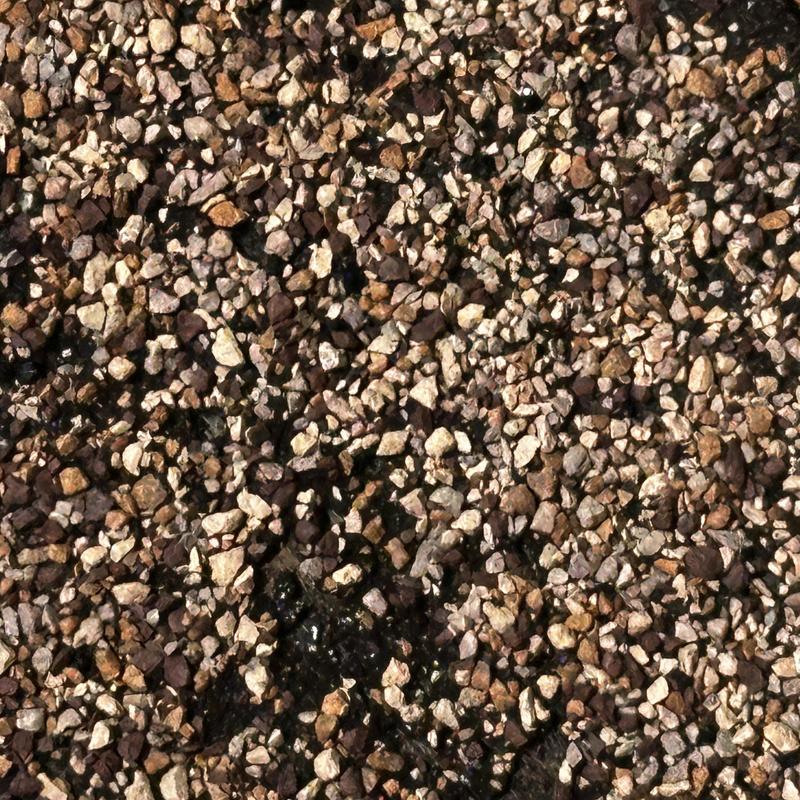 Roof gravel with hail damage and missing wood spots