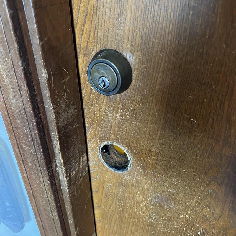 Deadbolt lock on wood door with missing handle hole
