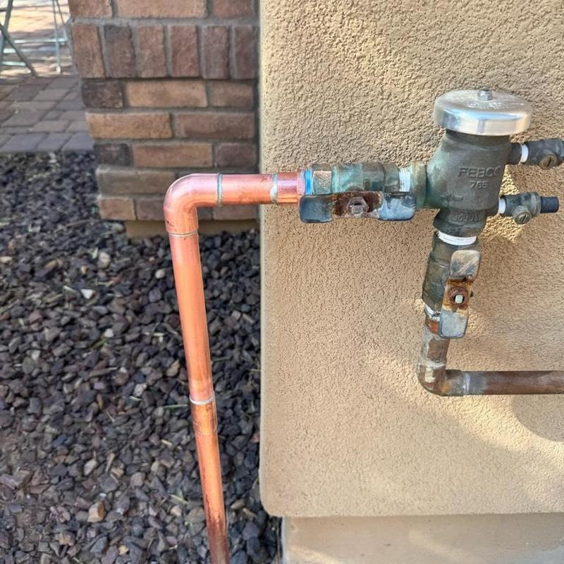 Copper pipe and pressure vacuum breaker near wall
