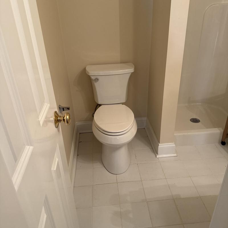 Comfort height toilet installation in small bathroom