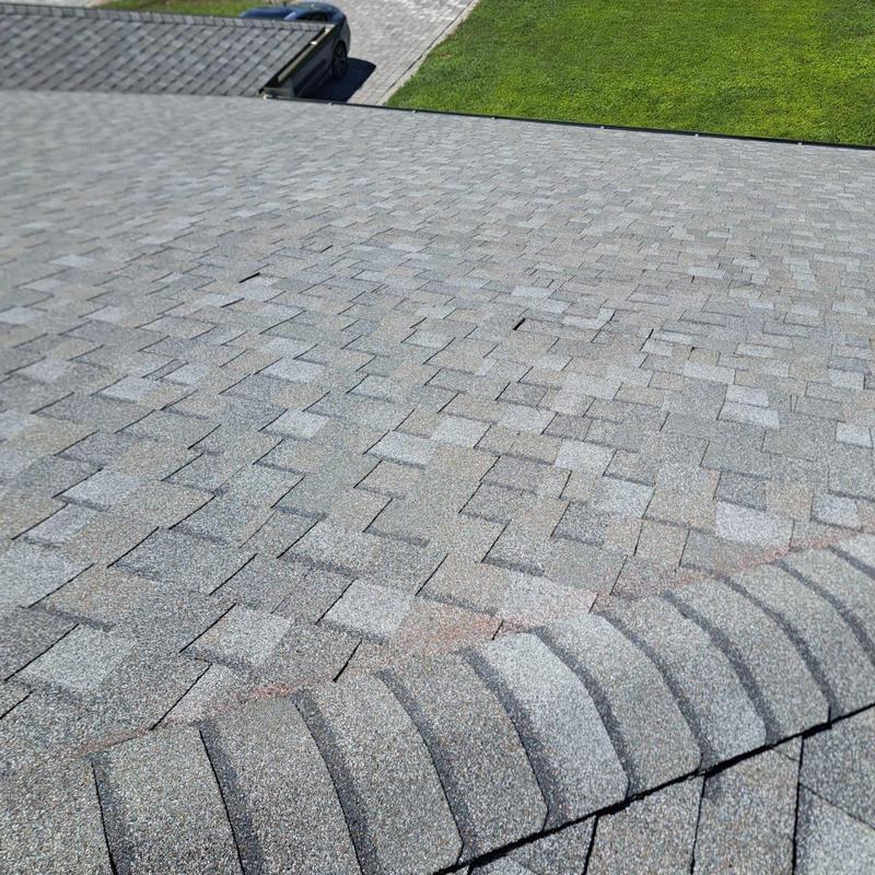 Asphalt shingle roof with repaired damaged shingles