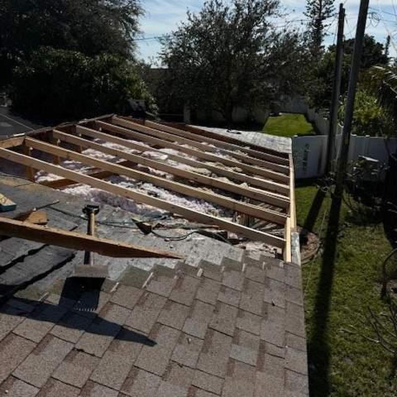 Roof decking with removed shingles and exposed framing