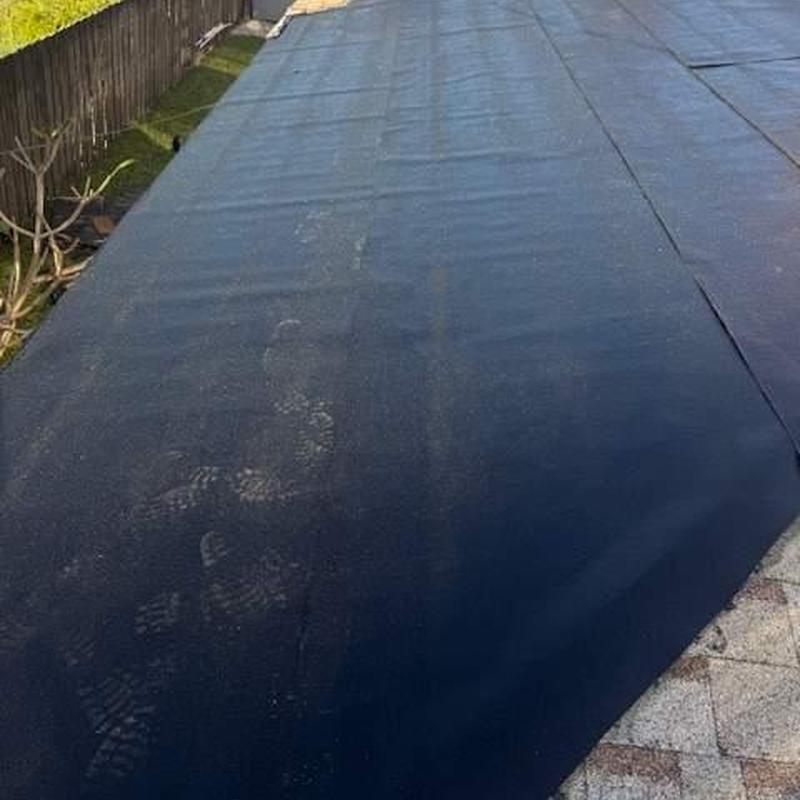 Flat roof underlayment installation on residential home