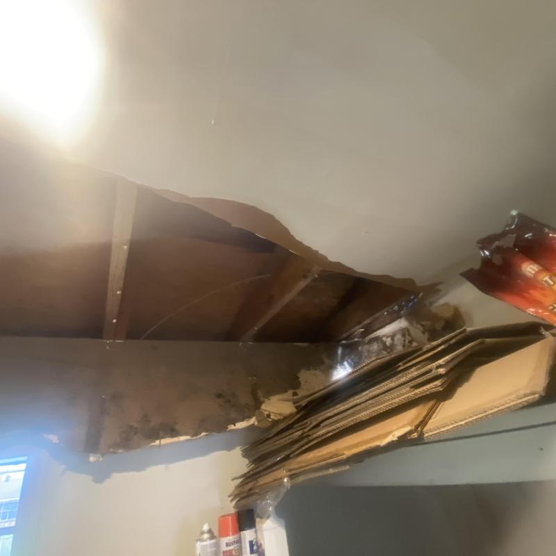 Ceiling drywall water damage with exposed wood beams