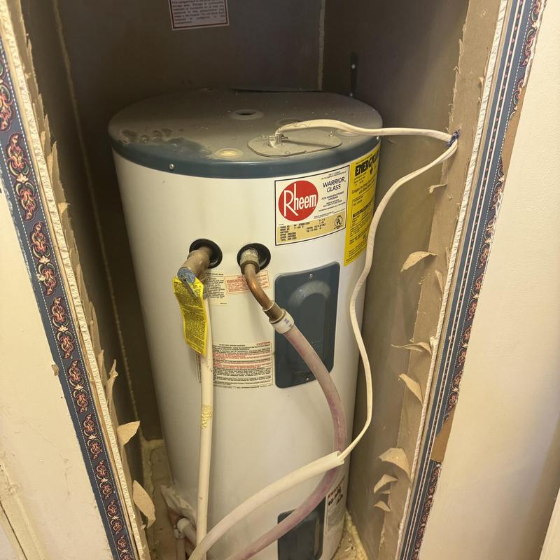 Water heater unit with plumbing and electrical wiring