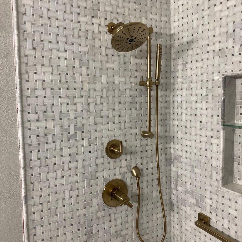 Brushed gold shower system with mosaic tile walls