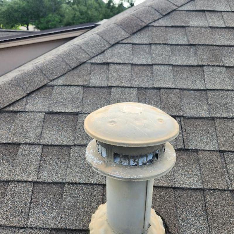 Roof vent pipe with worn and cracked sealant on shingles Roof vent pipe with worn and cracked sealant on shingles
