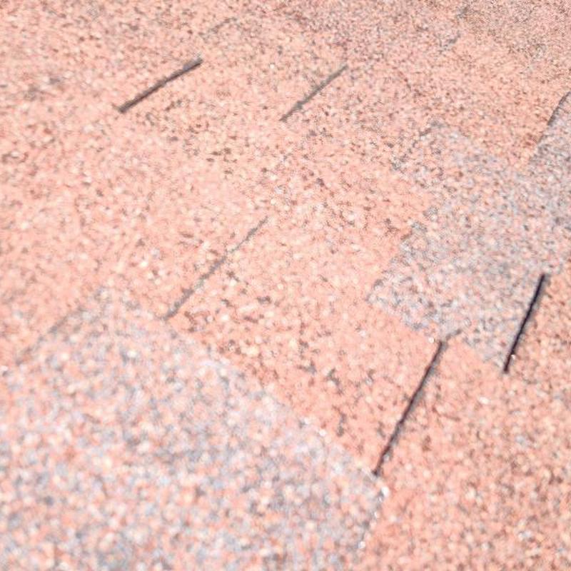 Asphalt shingle roof with minor hail damage close-up