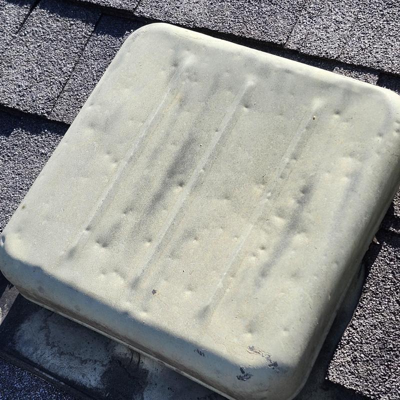 Roof vent cover with hail damage on shingles Roof vent cover with hail damage on shingles