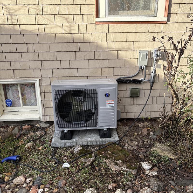 Variable speed heat pump installed on house exterior Variable speed heat pump installed on house exterior