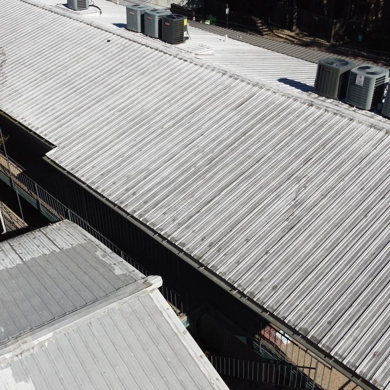 Exposed fastener metal roof on commercial building