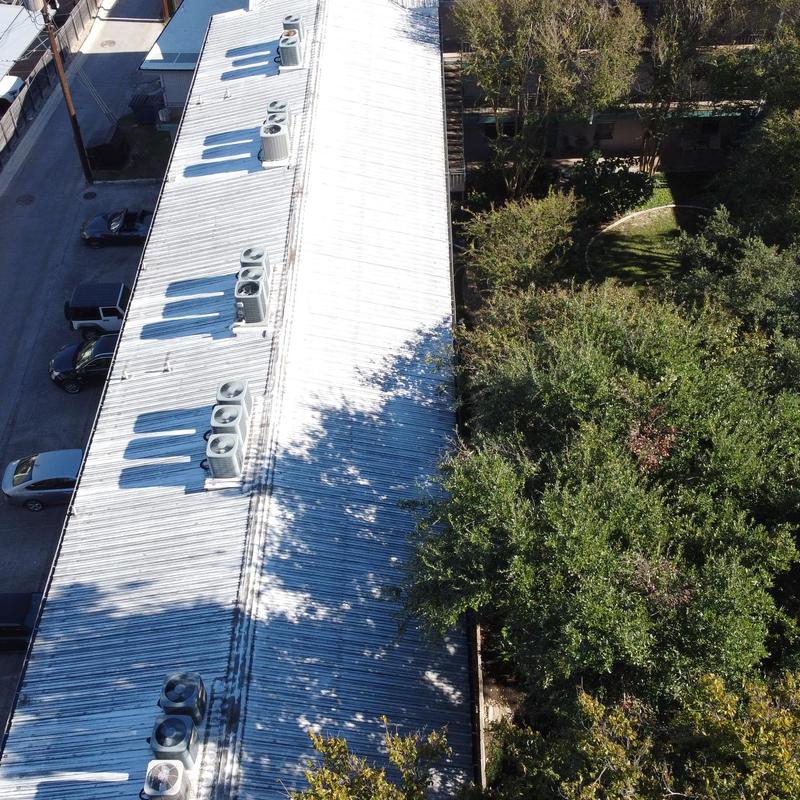 Exposed fastener metal roof with rooftop HVAC units