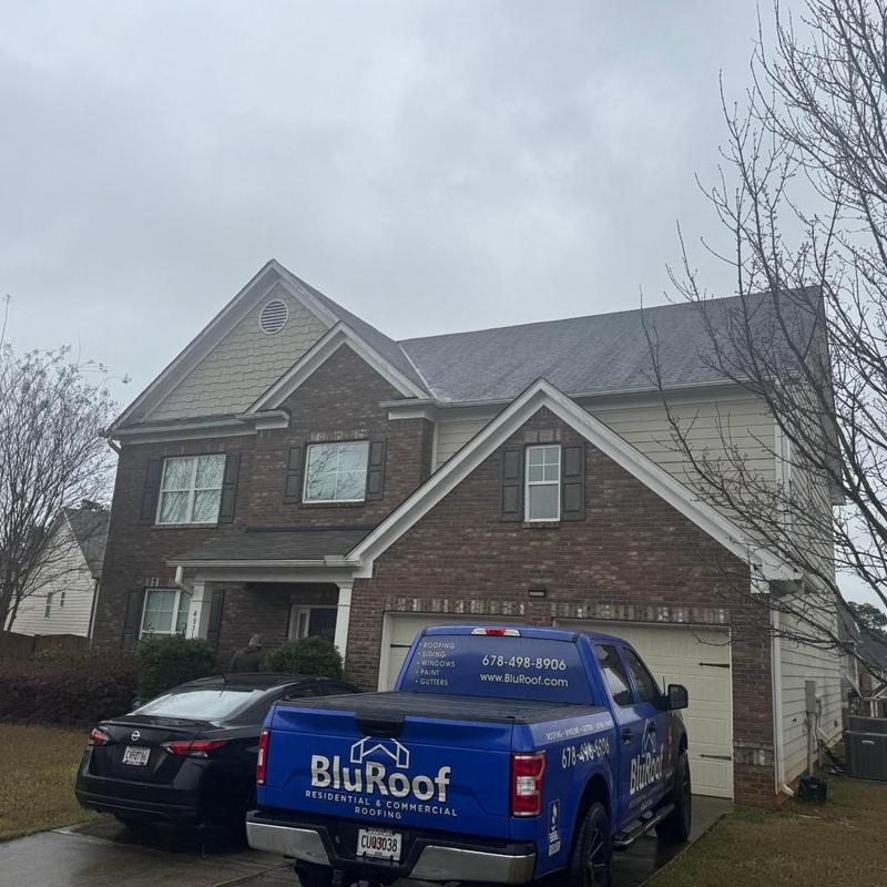 Roof shingles with wind damage inspection at house