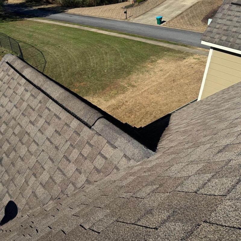 Asphalt shingle roof with loose shingles after storm