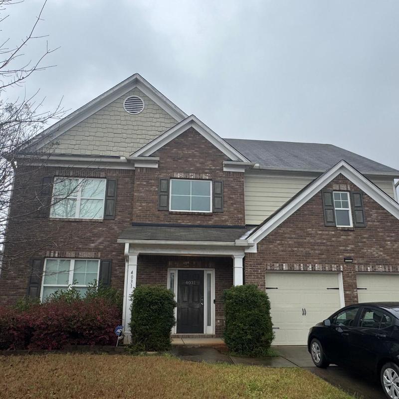Asphalt shingle roof with wind damage and loose shingles