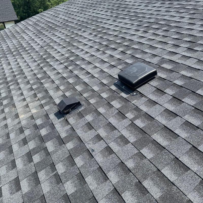 Roof shingles and vents with recent storm damage