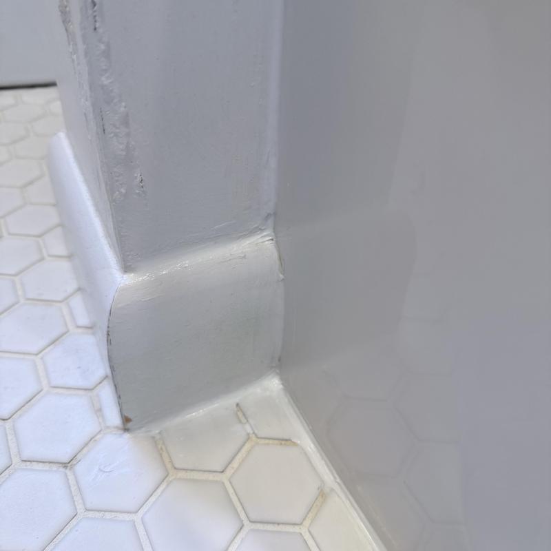 Silicone tub sealant on hex tile flooring corner Silicone tub sealant on hex tile flooring corner