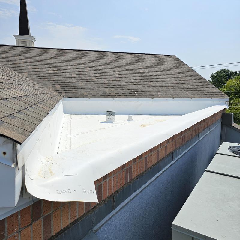 Flat roof membrane installation on brick building
