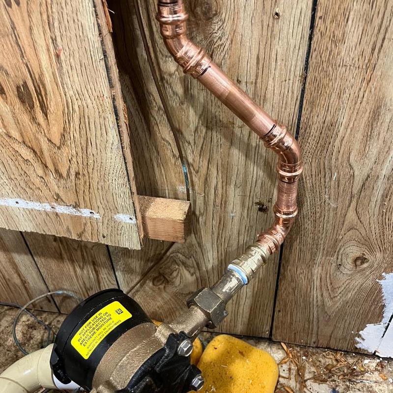 Copper pipe and valve installation on wooden wall